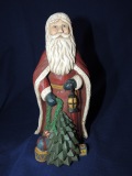 Santa with toys and small tree